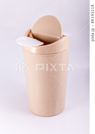 Plastic beige trash bin isolated on white background Plastic beige trash bin isolated on white background 86193218