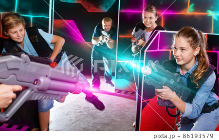 Happy teen brother and sister standing with laser pistols during Happy teen brother and sister standing with laser pistols during 86193579