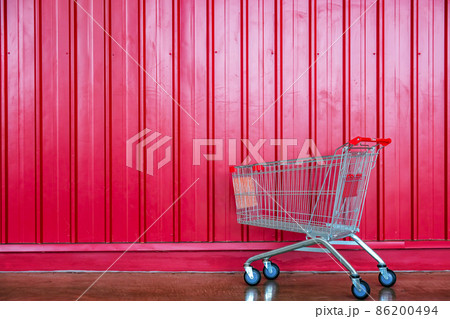 shopping cart on red wall shop background shopping cart on red wall shop background 86200494