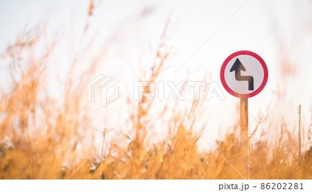 Traffic street transportation sign over dried grass nature meadow field Traffic street transportation sign over dried grass nature meadow field 86202281