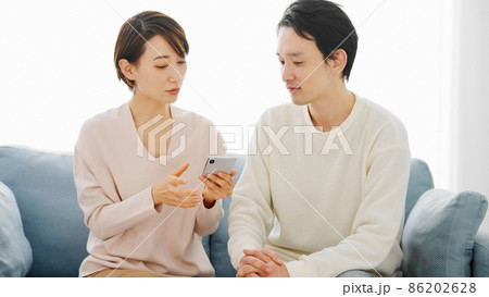 スマートフォンで調べ毎をするカップル スマートフォンで調べ毎をするカップル 86202628