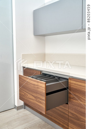 Minimalist style kitchen of walnut wood and gray color with acrylic solid surface countertop Minimalist style kitchen of walnut wood and gray color with acrylic solid surface countertop 86203459
