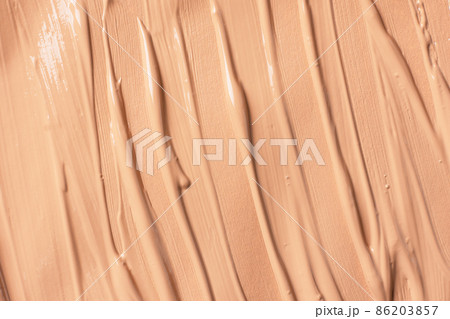 Liquid foundation texture top view. Beige liquid foundation background. Liquid foundation texture top view. Beige liquid foundation background. 86203857