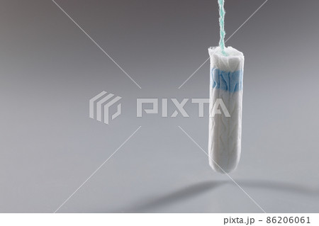 Medical hygienic female tampon, cotton swab on grey background 86206061