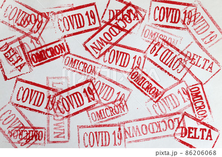 Red ink stamps covid19 and omicron delta lockdown closeup background 86206068