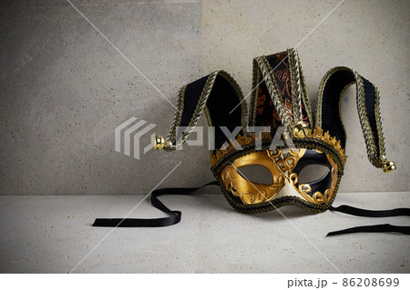 Venice carnival mask on travertine stone wall. Venice carnival mask on travertine stone wall. 86208699