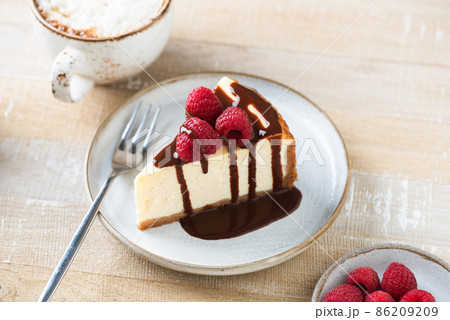 Cheesecake slice with chocolate sauce Cheesecake slice with chocolate sauce 86209209