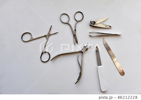Manicure accessories scissors and file on a white background 86212228