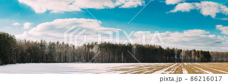 Spring Plowed Field Partly Covered Winter Melting Snow Ready For New Season. Ploughed Field In Early Spring. Farm, Agricultural Landscape. Panorama, Panoramic View 86216017