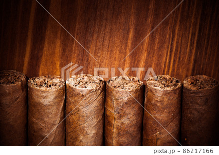 cigars on wooden background cigars on wooden background 86217166