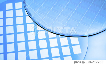 Several silicon wafers with printed circuits and microchips.Blue tone. 86217730