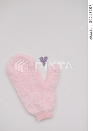 Minimal flat lay composition of massage mitten washcloth and a heart made of violet powder on a white background. Concept of zero waste Minimal flat lay composition of massage mitten washcloth and a heart made of violet powder on a white background. Concept of zero waste 86218107