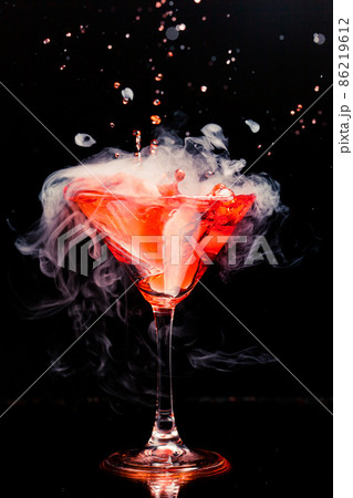 red cocktail with splash and ice vapor red cocktail with splash and ice vapor 86219612