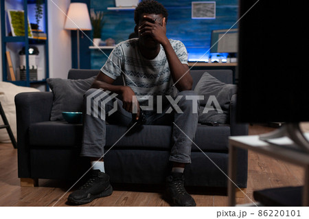 Sad upset cyber player playing video games on television 86220101