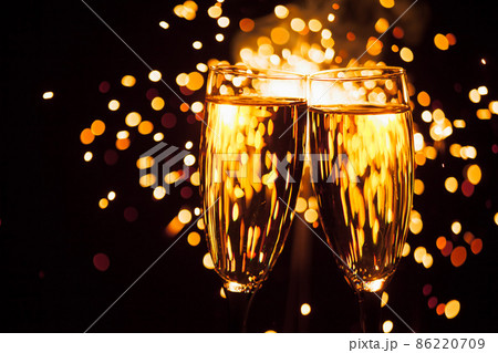 champagne glass against christmas sparkler background 86220709