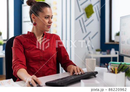 Content businesswoman reading chart on computer screen. 86220962