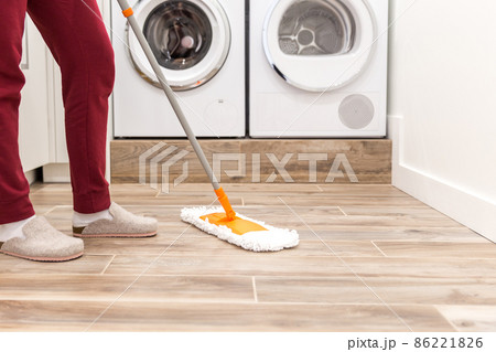 Cleaning floor in laundry room in modern house Cleaning floor in laundry room in modern house 86221826