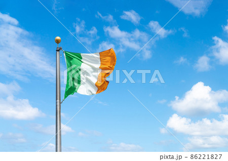 Irish tricolour flying in full sunshine against blue sky Irish tricolour flying in full sunshine against blue sky 86221827