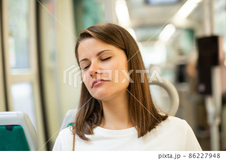 Woman sleeping in modern streetcar Woman sleeping in modern streetcar 86227948