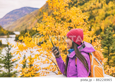 Autumn hiker camping woman talking on ham radio Autumn hiker camping woman talking on ham radio 86228965
