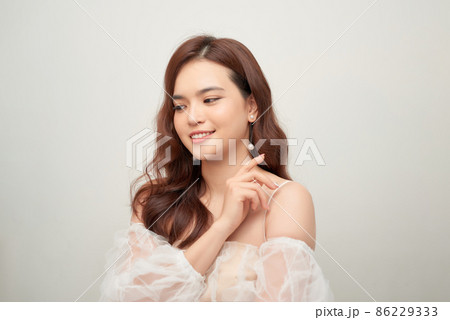 Close-up portrait of beautiful young lady with stylish makeup and curly long healthy hair 86229333