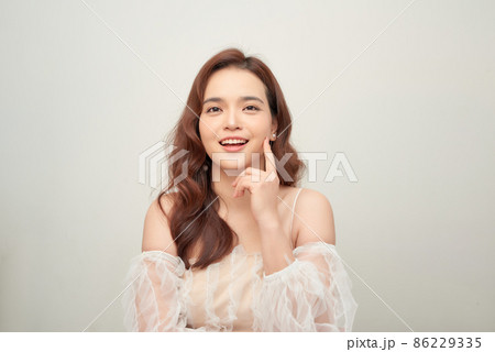 young woman in lace dress touching face and looking away isolated on white young woman in lace dress touching face and looking away isolated on white 86229335