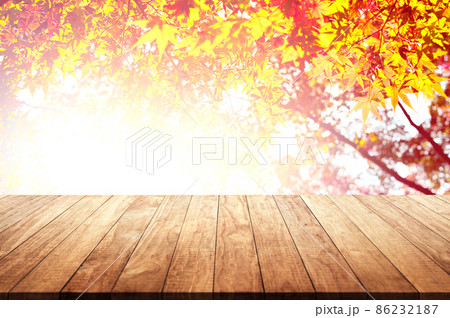 Wooden table top with orange fall leaves, autumn natural background Wooden table top with orange fall leaves, autumn natural background 86232187