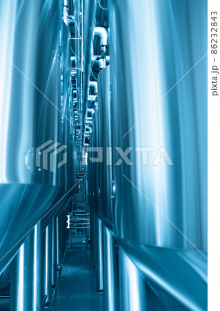 Private microbrewery. Industrial interior of modern craft brewery with chrome cylindrical metal beer tanks. Private microbrewery. Industrial interior of modern craft brewery with chrome cylindrical metal beer tanks. 86232843