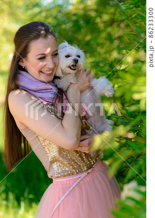Puppy white dog with it's owner. Concept about friendship, animal and freedom. 86233300