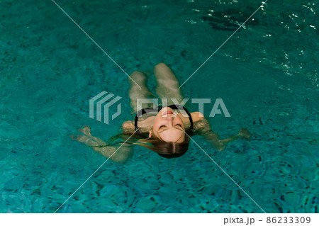 Portrait of beautiful woman in swimwear relaxing in swimming pool spa. Portrait of beautiful woman in swimwear relaxing in swimming pool spa. 86233309