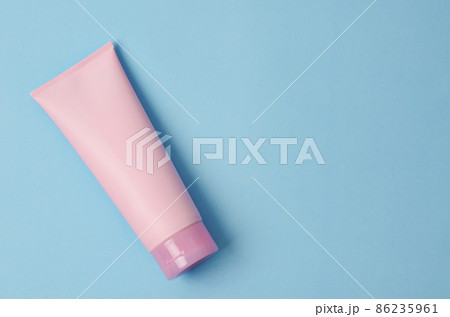 Empty a cosmetic pink tube of cream on blue background 86235961