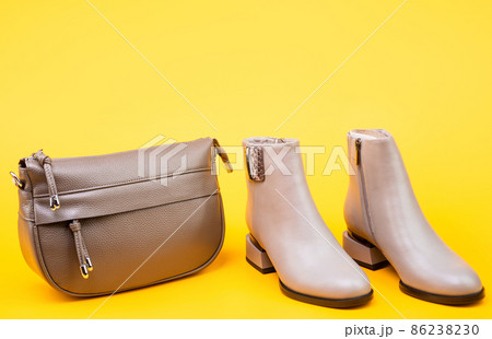 beige boots. ankle boots on yellow background. shoe store. shopping concept. 86238230