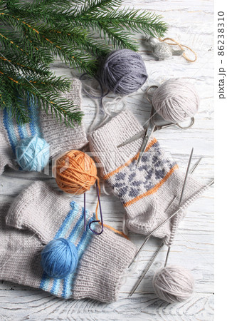 Flat lay of knitting and winter accessories on white background 86238310