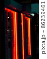 Blurred neon orange light banner outside shop in the evening 86239461
