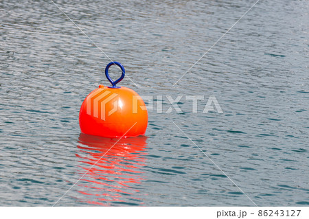 Red Buoy for safety swimming in water 86243127