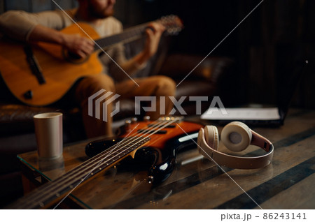 Male guitar player enjoy online training lesson 86243141
