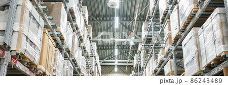 Rows of shelves with boxes in modern warehouse 86243489