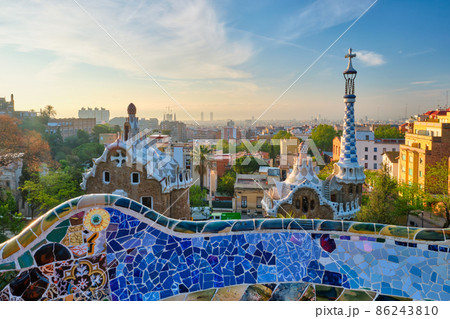 Barcelona city view from Guell Park. Sunrise view of colorful mosaic building in Park Guell Barcelona city view from Guell Park. Sunrise view of colorful mosaic building in Park Guell 86243810