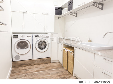 Laundry room with washing machine in modern house Laundry room with washing machine in modern house 86244059