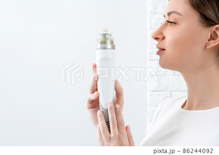 Cosmetologist holding medical laser head for rejuvenating face and body treatments Cosmetologist holding medical laser head for rejuvenating face and body treatments 86244092