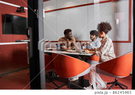 Group of young people using laptop and smiling while sitting at the table 86245965