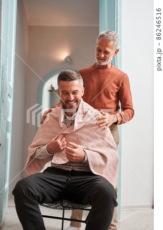 Mature man preparing to making haircut for his adult son at the house 86246516