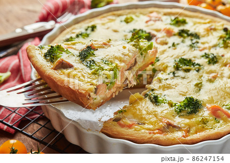 Homemade quiche with red fish, salmon, broccoli and cheese on wooden background 86247154