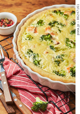 Homemade quiche with red fish, salmon, broccoli and cheese on wooden background 86247161