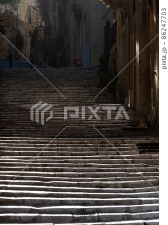 The Melita street, called Triq Melita, with nature stone stairs and houses, covered in counter light The Melita street, called Triq Melita, with nature stone stairs and houses, covered in counter light 86247703