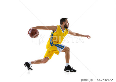 Studio shot of professional basketball player training isolated on white studio background. Sport, motion, activity, movement concepts. 86248472