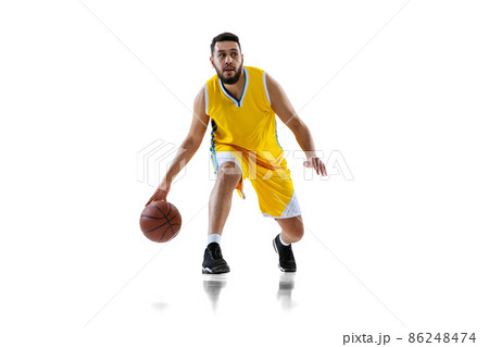 Full length portrait of professional basketball player training isolated on white studio background. Sport, motion, activity, movement concepts. 86248474