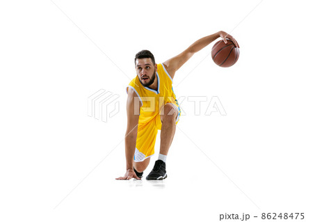 Studio shot of professional basketball player training isolated on white studio background. Sport, motion, activity, movement concepts. 86248475
