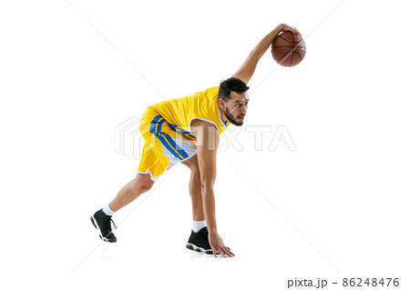 Full length portrait of professional basketball player training isolated on white studio background. Sport, motion, activity, movement concepts. 86248476