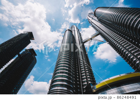 Tall modern skyscrapers in sunny day under blue sky 86248491